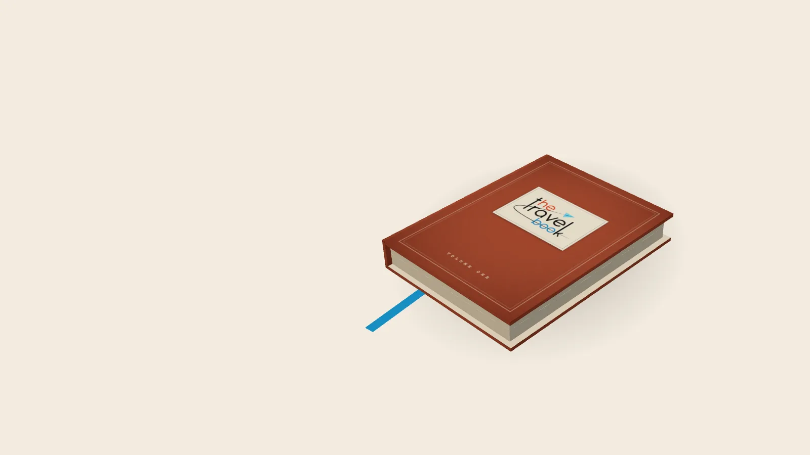 A red cloth-bound travel book with The Travel Book label on its cover, lying on a desk with a blue ribbon bookmark