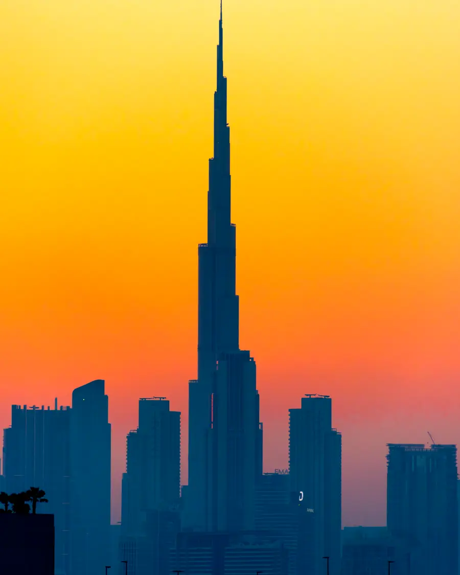 The Burj Khalifa in silhouette against an orange evening sky, Dubai