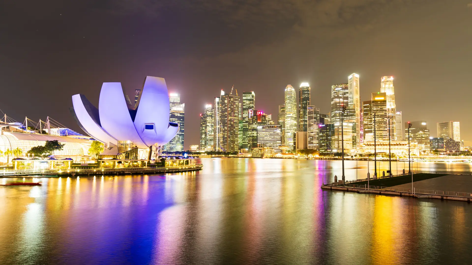 The Singapore skyline and the ArtScience Museum reflected in Marina Bay at night